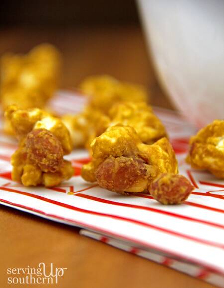 Oven-Baked Caramel Popcorn with nuts on a popcorn bag.