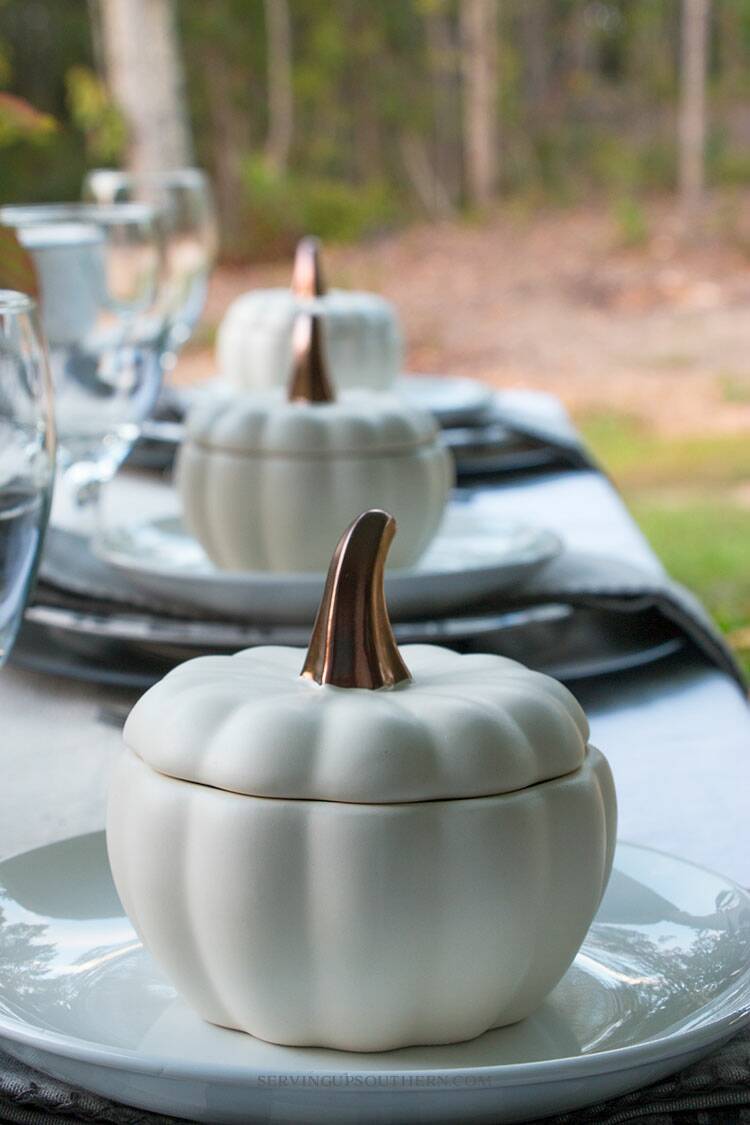 Table decorated for fall on a back porch.