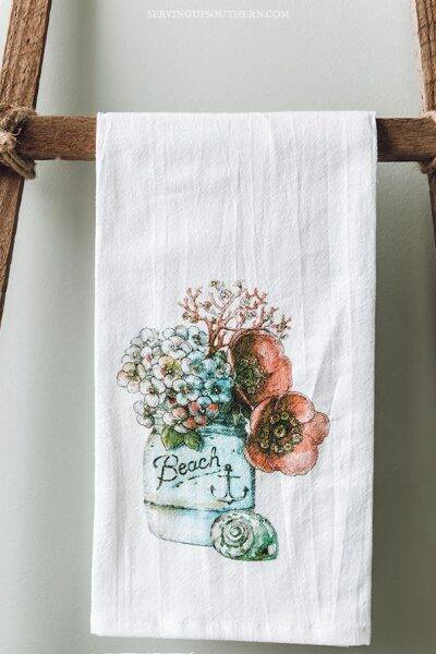 A pretty hand towel hanging on a tobacco stick ladder.