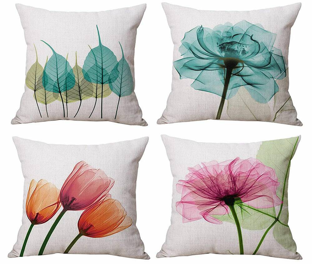 Four pillow covers with water color flowers on each one.