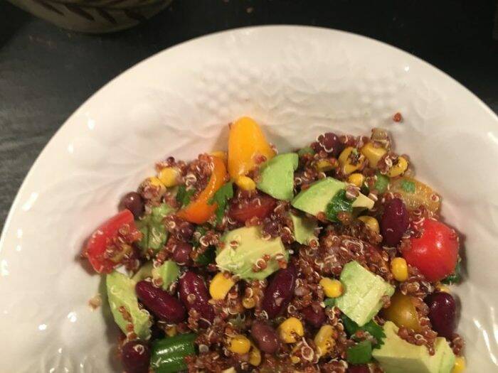 homestyle gathering 15 A helping of hearty quinoa salad on a white plate .