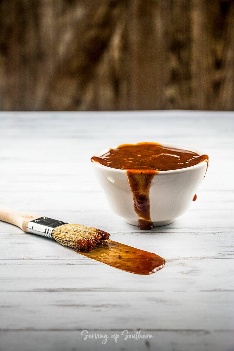 Picture of old bay homemade barbecue sauce in a white bowl with a basting brush