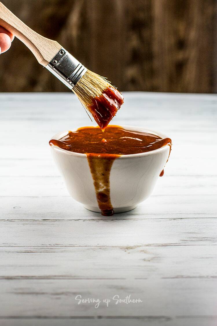 Picture of old bay homemade barbecue sauce in a white bowl with a basting brush