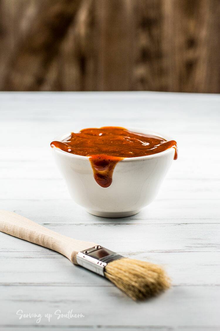 Picture of old bay homemade barbecue sauce in a white bowl with a basting brush