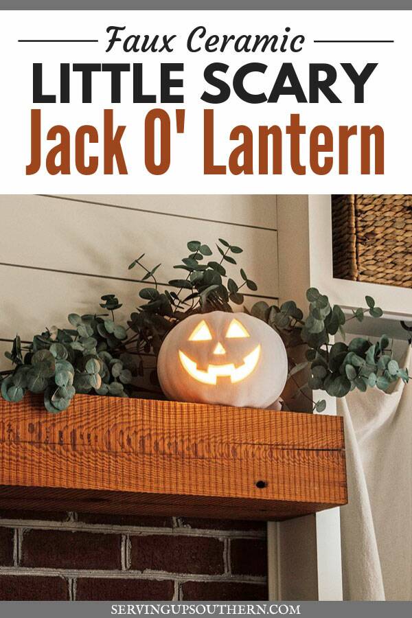 Pinterest graphic of a white painted Jack O' Lantern lit up and sitting on a mantel with eucalyptus .