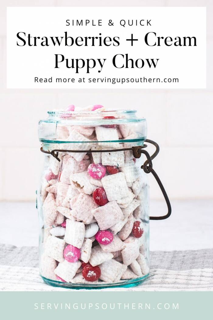 Pinterest graphic of a blue ball jar filled with strawberries and cream puppy chow snack.