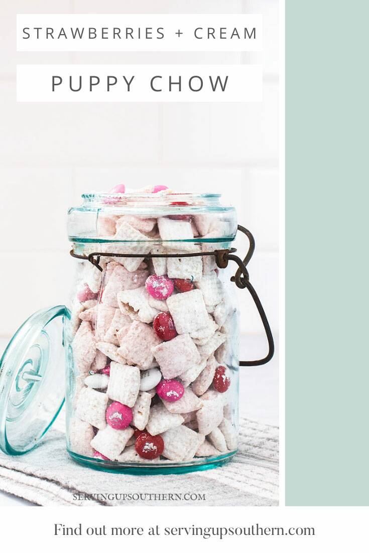 Pinterest graphic of a blue ball jar filled with strawberries and cream puppy chow snack.